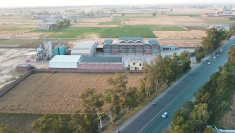 Drone-view-of-a-rice,flour-mill-and-agricultural-field-in-Pakistan,-village-life-in-Pakistan