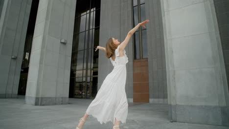 woman in a white dress in front of a modern building