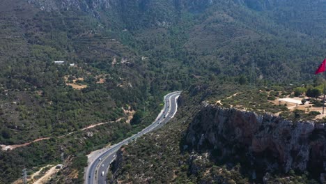 Flying-high-above-the-highway-that-cuts-through-the-mountains-near-Nicosia