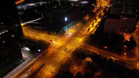 midnight traffic in katowice city - illuminated intersection, drone view 4k