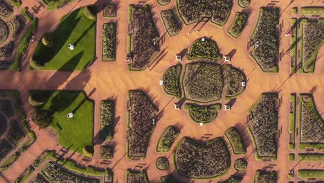 Aerial-top-down-shot-of-two-people-walking-on-path-at-Palermo-park,Buenos-Aires-during-sunlight---Circular-pattern-texture-from-above