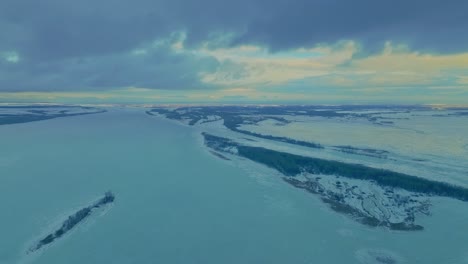 copter flies over frozen lakes and rivers, natural spaces. frosty winter day, white ice covers rivers and lakes. trees stand on the banks, a beautiful landscape. 4k, prores