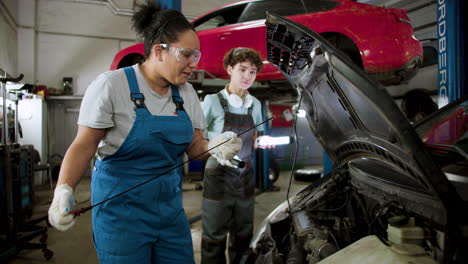 women inspecting automobile