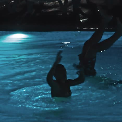 swimming pool at a luxury, tropical resort at night