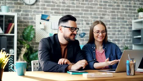 cinemagraph loop of happy coworkers using laptop while steam going up from drink