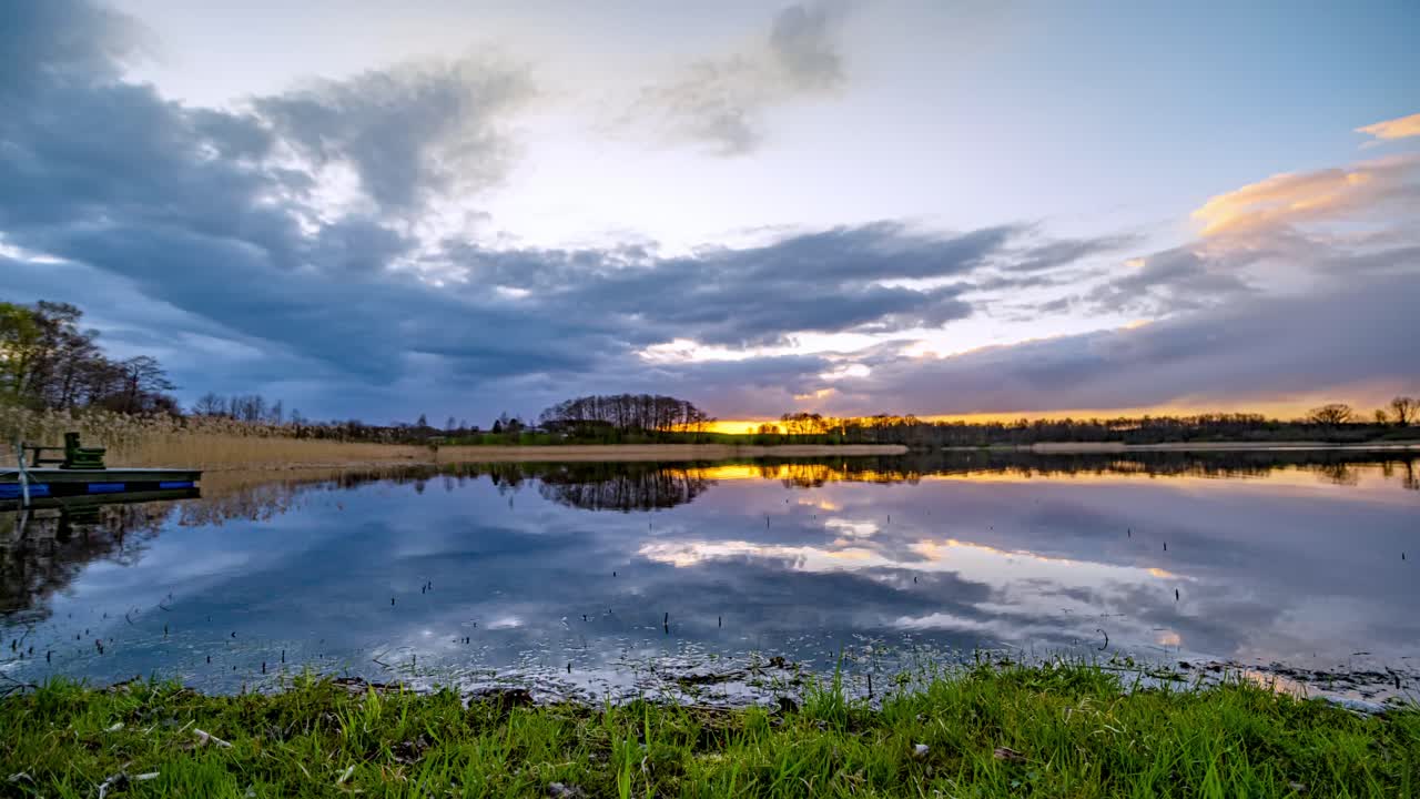 Colorful Sunset Sky on a Lake, Kashubia, Poland. Clouds Reflection in Calm Water