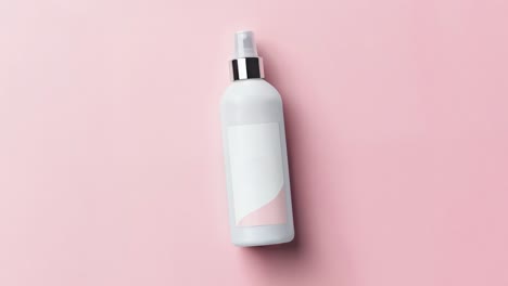 blank white spray bottle mockup on pink background