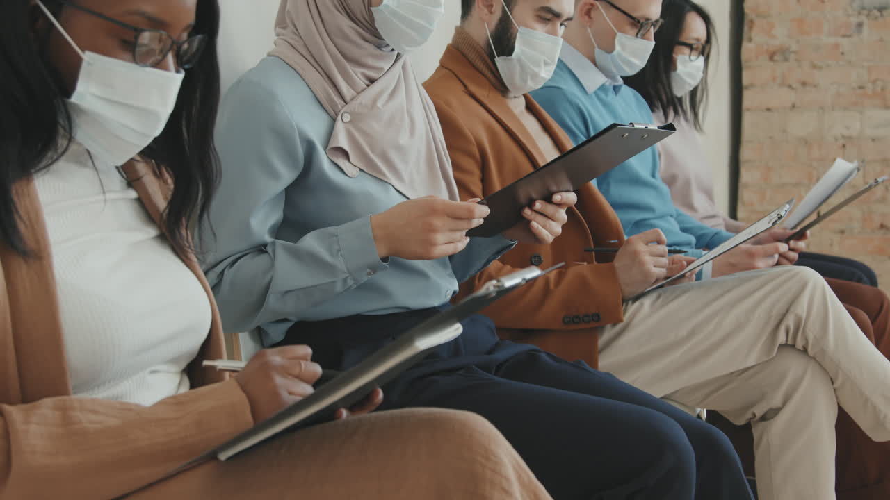 People in Face Masks Waiting for Job Interview