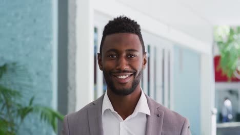 portrait of smiling african american businessman in cafe