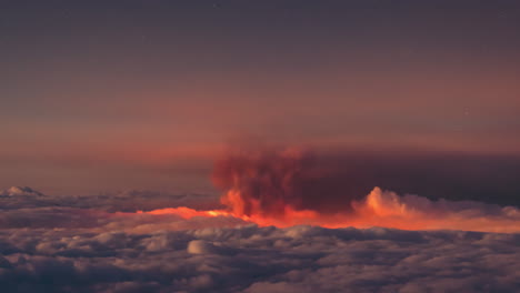 night time lapse of volcanic ash cloud and sea of clouds in la palma island during volcano eruption in september 2021