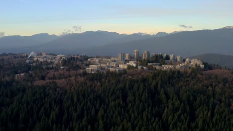 towering buildings of simon fraser university on the forested mountain of burnaby in bc, canada