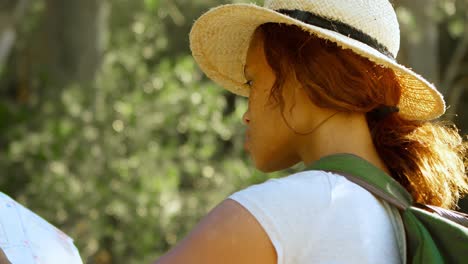 Female-hiker-looking-at-map-in-countryside-4k