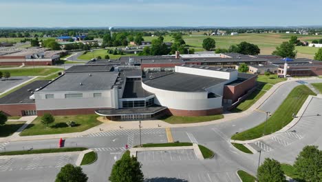 aerial circling view of campus grounds of american school