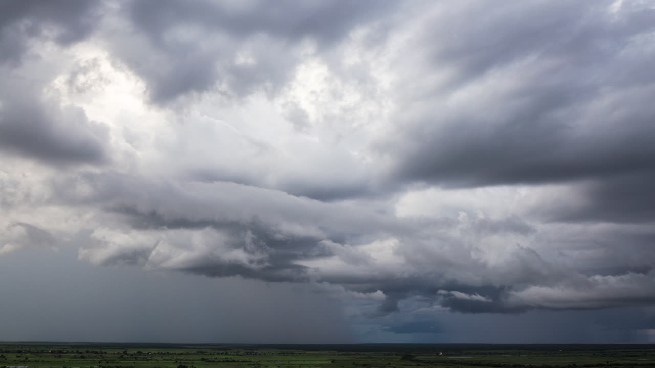 Pre storm cloud formations over rice paddy flat lands of south east Asia heading into monsoon season.