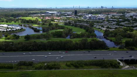 right to left aerial over the m1 and the glades, mudgeeraba, gold coast, queensland, australia