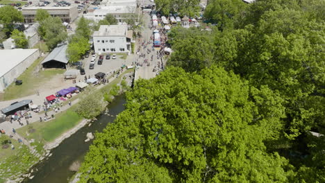 aerial view over siloam springs during dogwood festival in ar, usa - drone shot