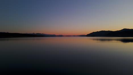 silhouetted mountains against sunset sky on senja island, norway