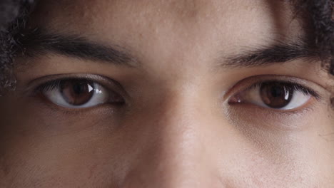 close up young man brown eyes looking at camera eyesight vision