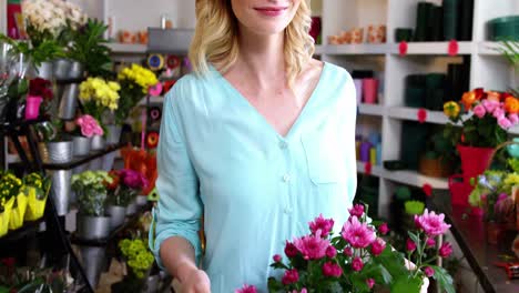 female florist holding bunch of flowers in flower shop