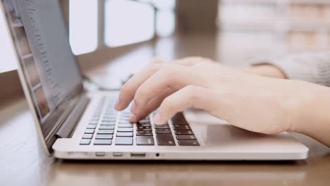 male hands of young businessman typing on laptop computer keyboard in working space. freelance lifestyle or educational research concepts.