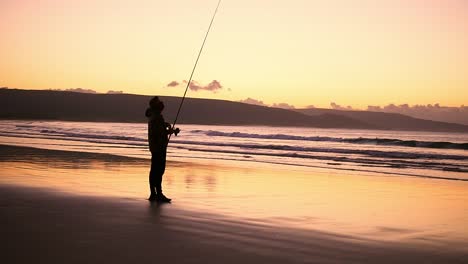 silhouette of a fisherman fishing with a fishing rod