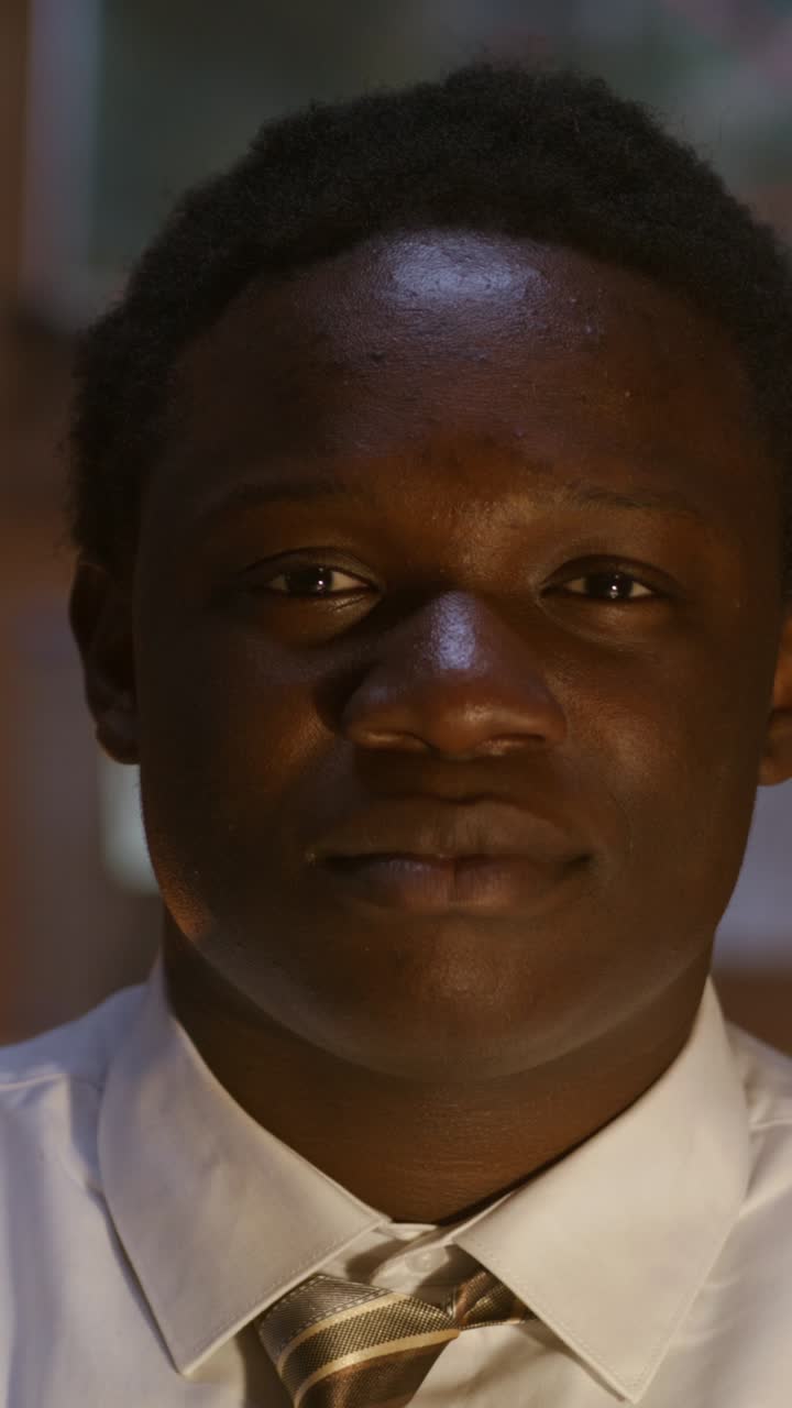 Close-up portrait of a young man in a business shirt.