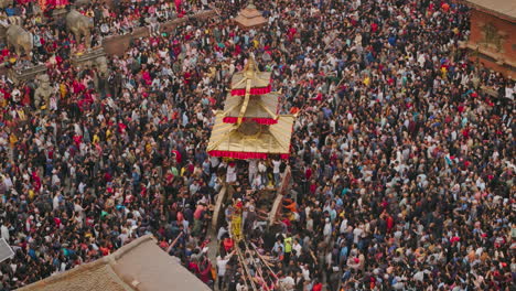 bisket jatra at bhaktapur durbar square, drone shot captures chariot pulling with newari tradition and cultural significance, as a large crowd gathers to celebrate prosperity in the kathmandu valley.