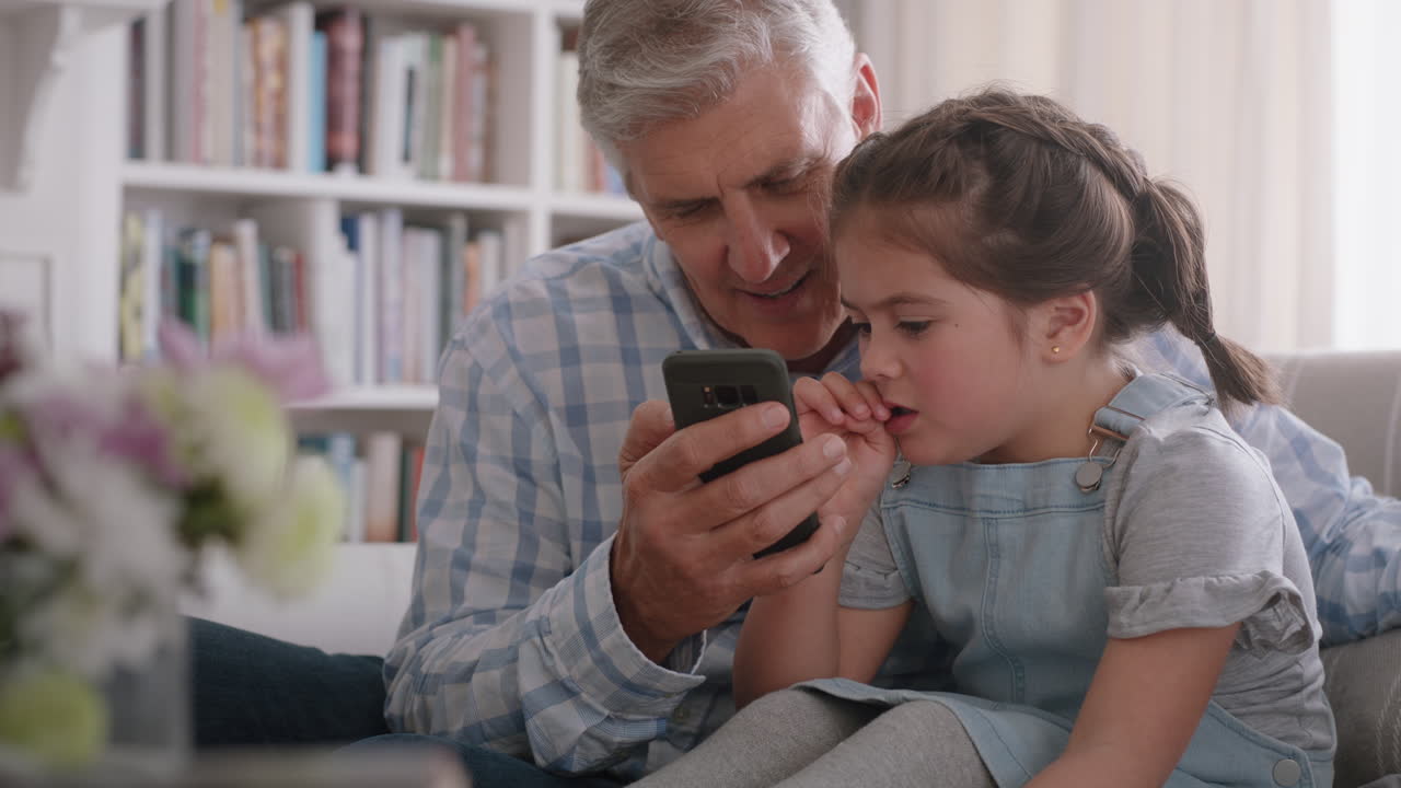 Premium stock video - Grandfather showing cute little girl how to use ...