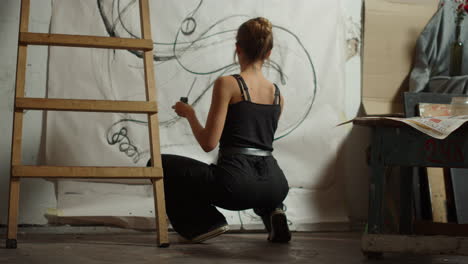 female artist painting in studio