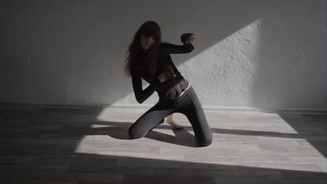woman in black outfit posing in a studio