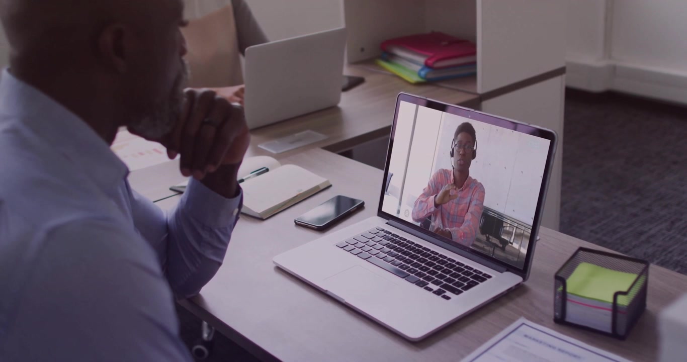 Businessman Having Video Call on Laptop in Modern Office