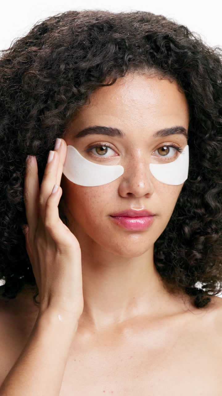 Woman applying eye patches