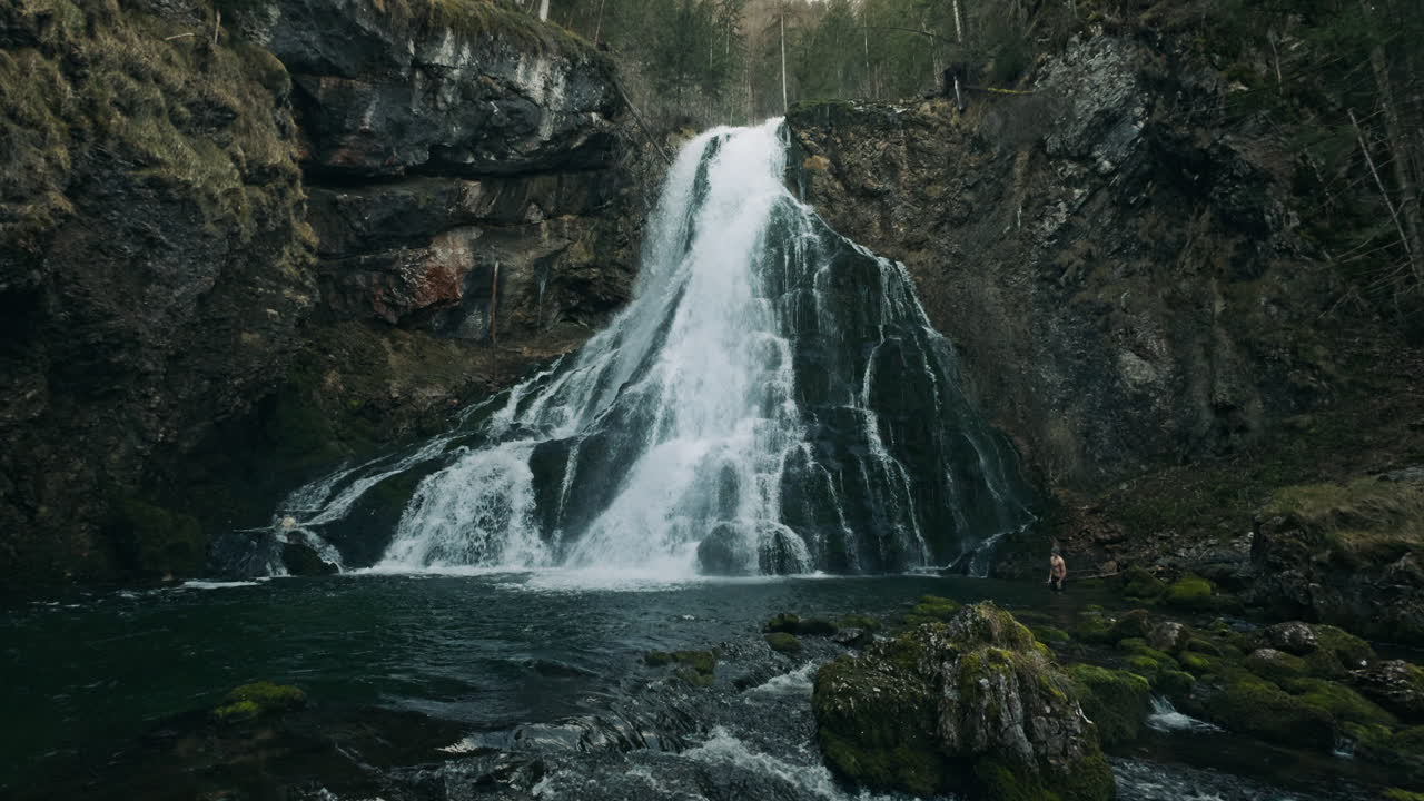 Mountain Waterfall with Person in the Water