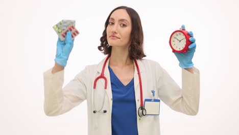 female doctor holding an alarm clock and medication
