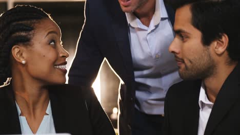 businessman discussing with colleagues over laptop