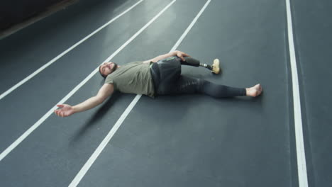 athlete with prosthetic leg stretching after workout