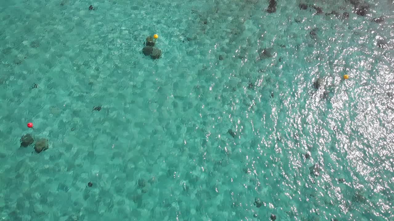Aerial vertical shot of the people swimming in azure water. Protaras, Cyprus