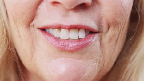 Close-Up-Of-Mouth-Of-Mature-Woman-As-She-Talks-To-Camera-In-Studio