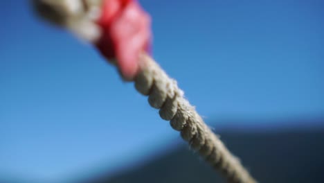 detalle de cuerda náutica con cielo y paisaje de fondo