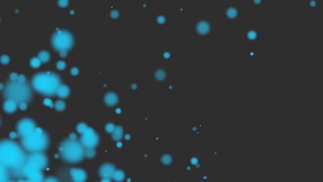 volar y caer partículas redondas azules con brillos en degradado negro