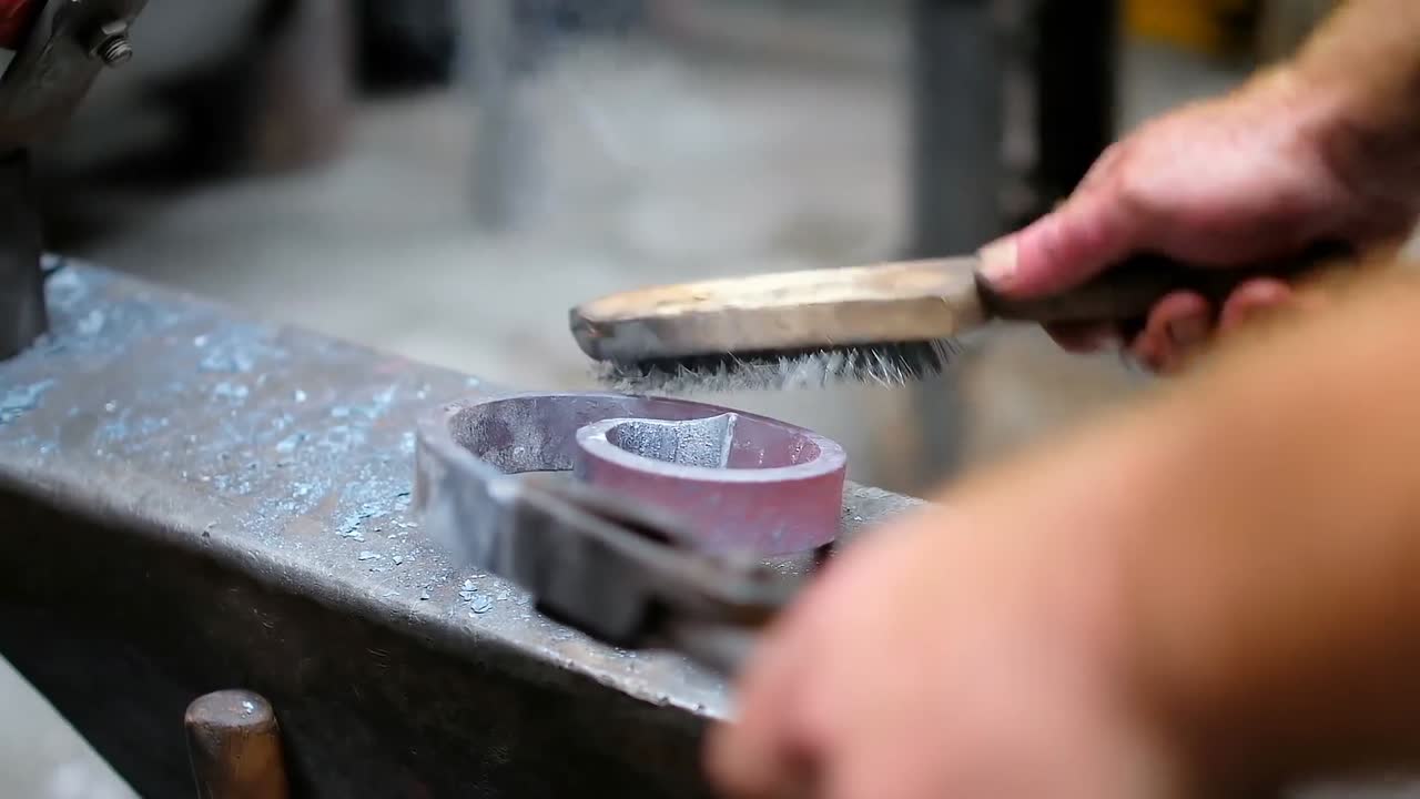 Blacksmith shaping the molten metal in workshop 4k