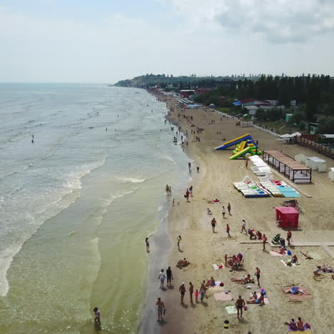 aerial view of beach with tourists, sunbeds and umbrellas at a luxury hotel. sea travel destination.