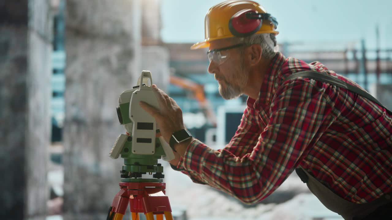 Professional Surveyor Working with Total Station at Construction Site