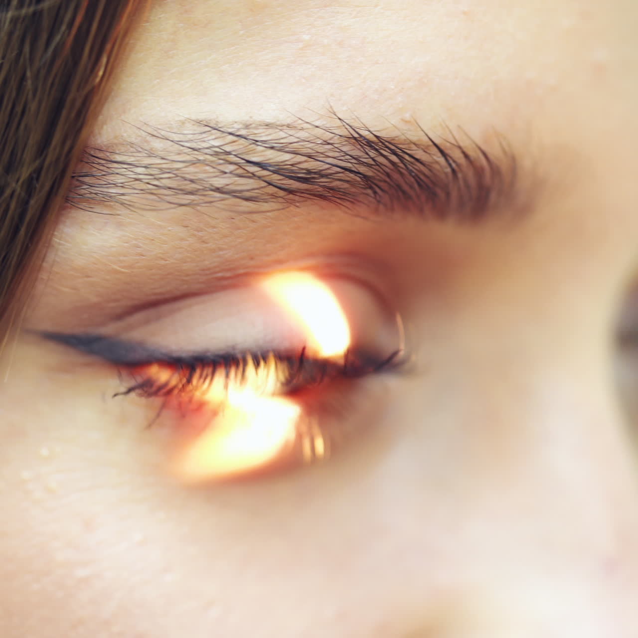 Eyes examination. Close-up woman's eyes checking by a doctor. Laser shining inside the eye. Eyesight concept.