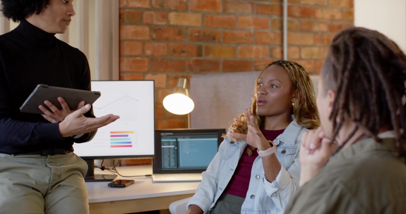 African American trio opening tablet project review office lead gesturing trio replying by screens