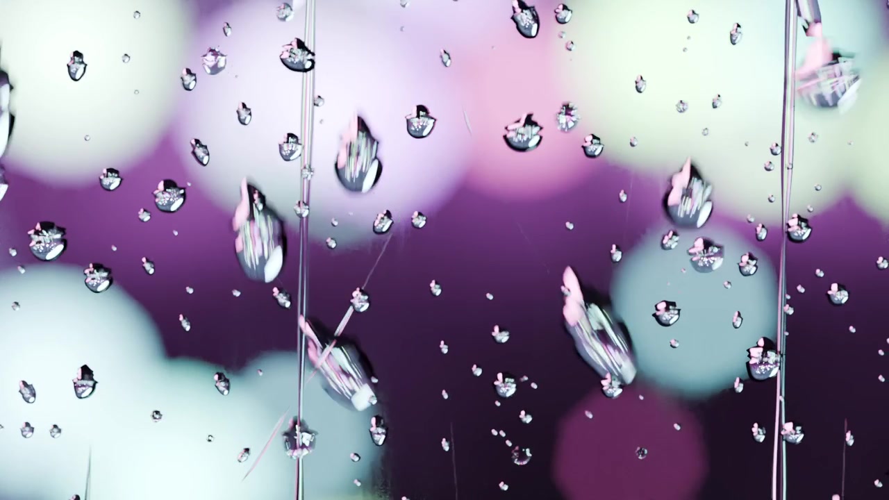 Gravity pulling cluster of water droplets, merging into vertical streaks on glass, bokeh