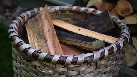 throwing a brick of chopped wood in the sack or basket to make a fire