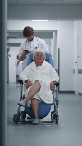 doctor stands with patient in transport wheelchair 4k 2025 08 04 21 45 14 utc.mov | assistance, care, clinic, corridor