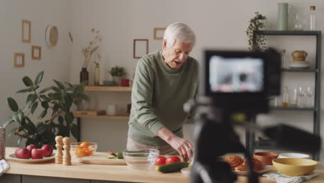 senior food blogger telling about vegetables on camera