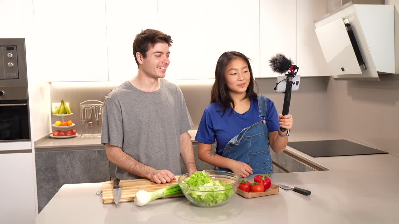 Couple taking a selfie while cooking in the kitchen